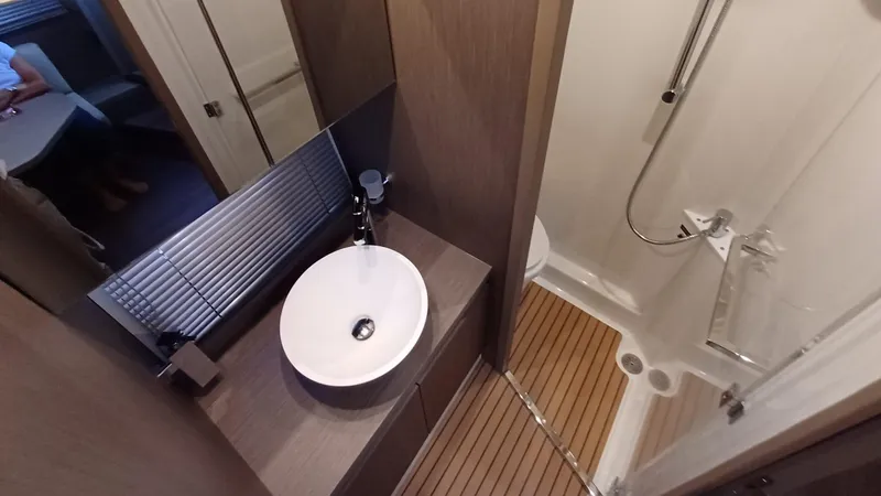  Yacht Photos Pics Bathroom interior of 2023 Beneteau Gran Turismo 41 yacht, featuring modern sink and shower.