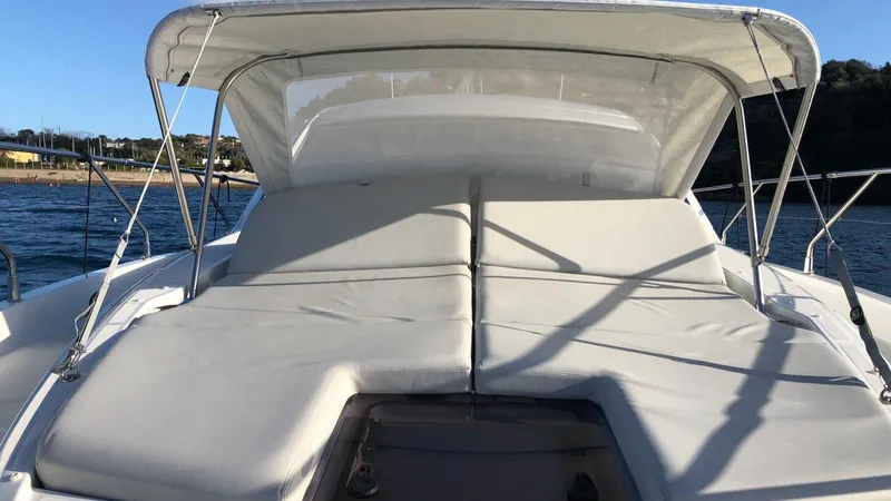  Yacht Photos Pics 2023 Beneteau Gran Turismo 41 yacht with sunbathing deck and canopy on the water.