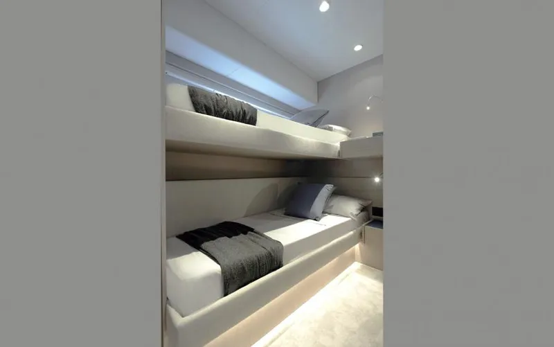  Yacht Photos Pics Luxurious 2025 Ferretti Yachts 500 cabin with modern bunk beds and elegant lighting.