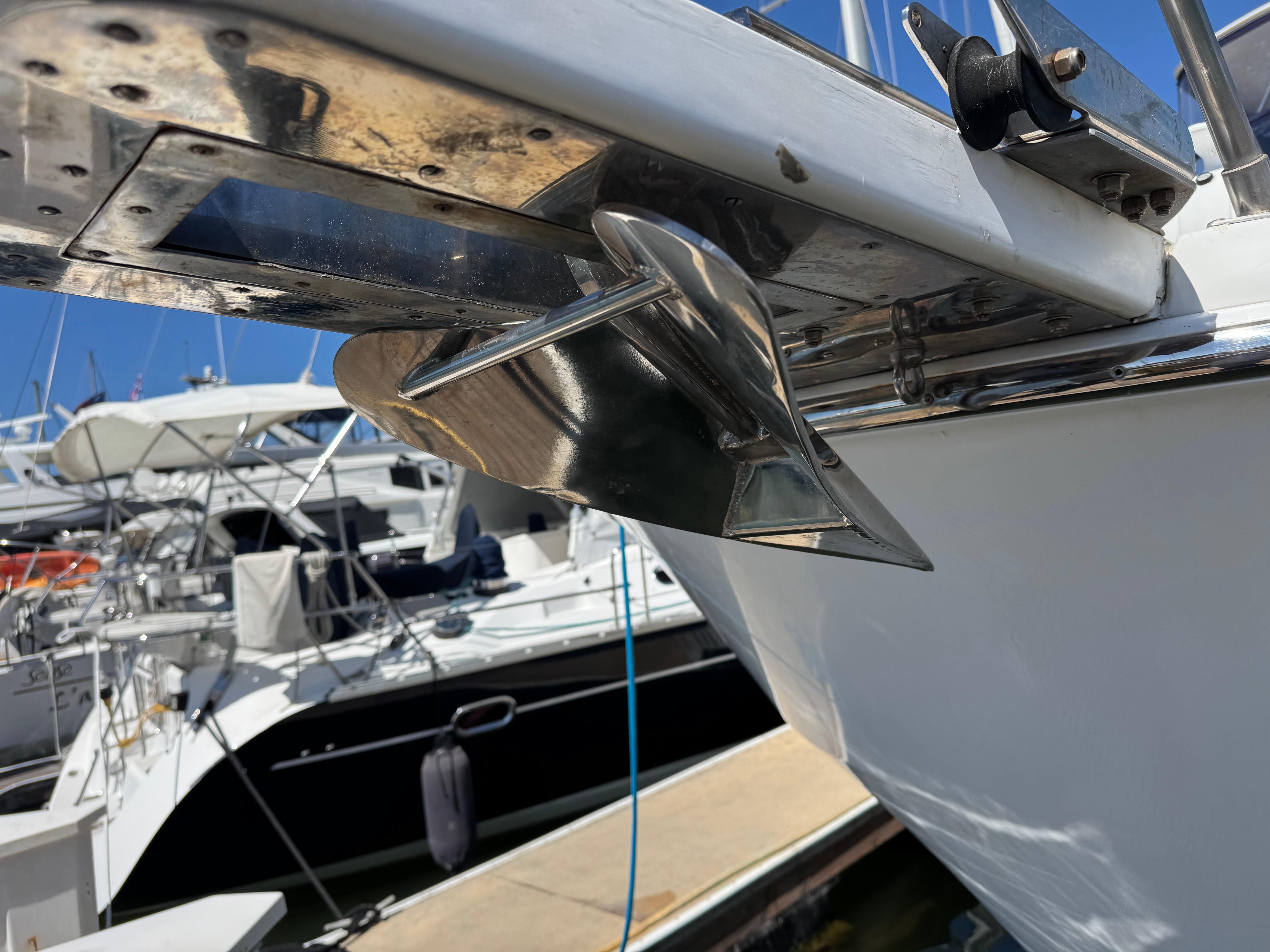Close-up of a Nova 48 boat anchor, docked at a marina, sunny day.