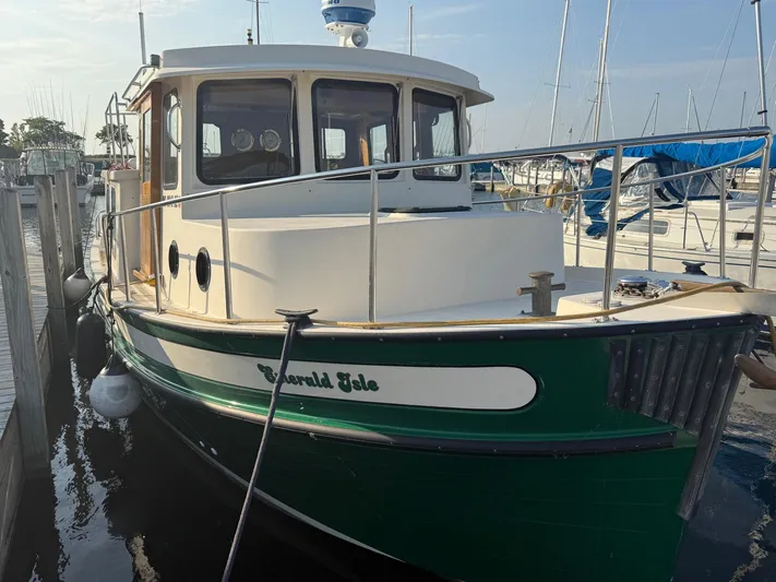 Emerald Isle Yacht Photos Pics 1998 Nordic Tug Trawler docked at marina, featuring green and white exterior.