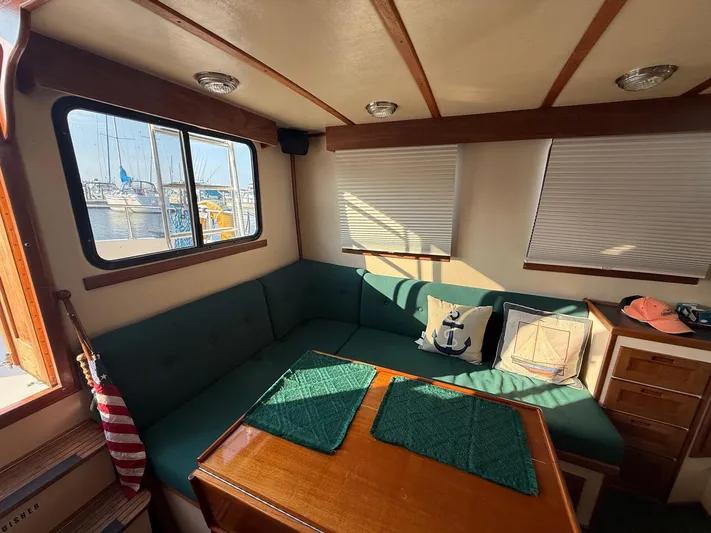 Emerald Isle Yacht Photos Pics Cozy interior of a 1998 Nordic Tug Trawler with nautical-themed decor.