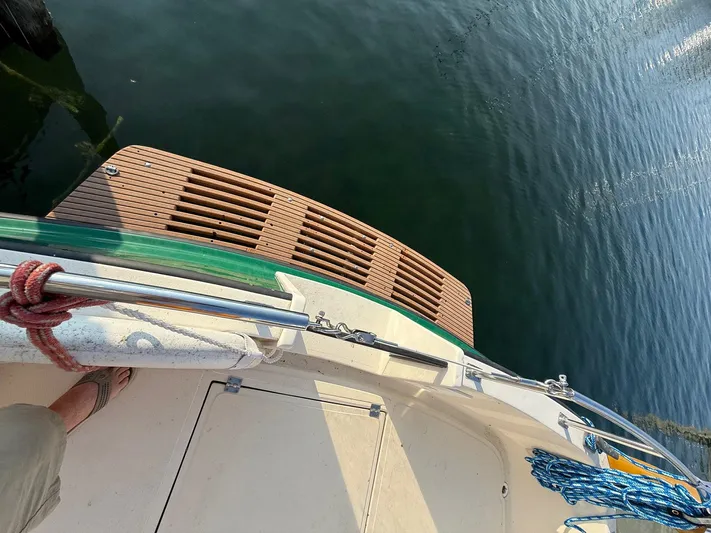Emerald Isle Yacht Photos Pics 1998 Nordic Tug Trawler deck with wooden platform and ropes, overlooking calm water.