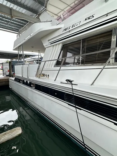 Daddy's Ju-al Yacht Photos Pics 1996 President 655 Flybridge Cockpit MY yacht docked in a marina.
