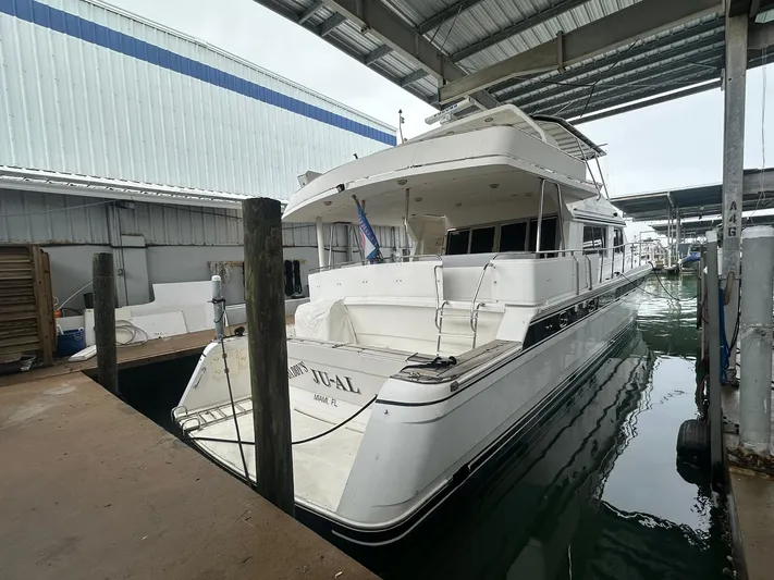 Daddy's Ju-al Yacht Photos Pics 1996 President 655 Flybridge Cockpit MY yacht docked in a covered marina.