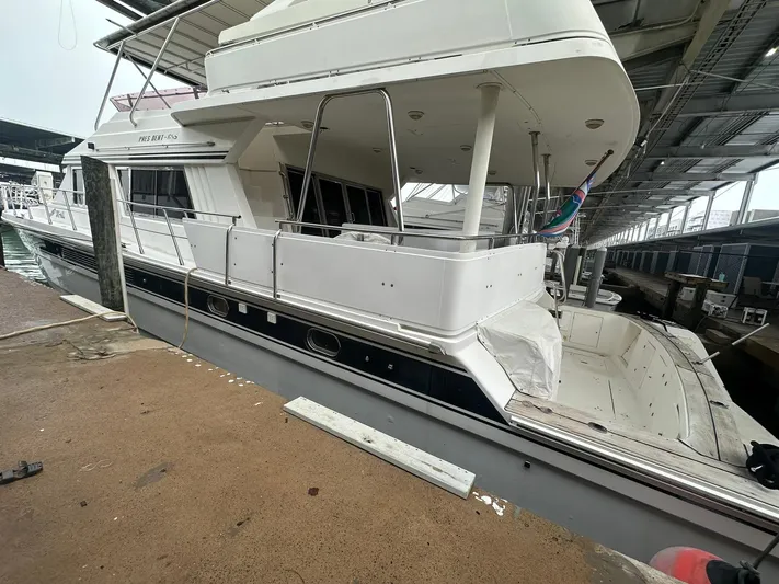 Daddy's Ju-al Yacht Photos Pics 1996 President 655 Flybridge Cockpit MY docked in a covered marina.