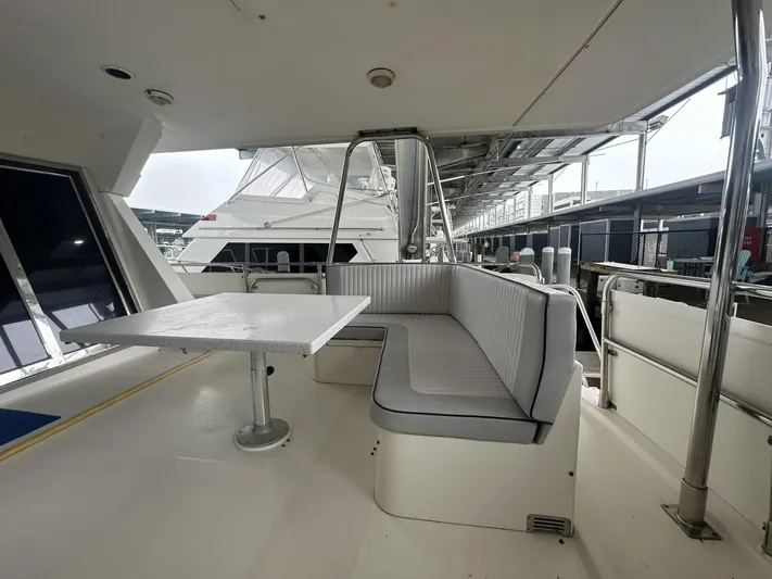 Daddy's Ju-al Yacht Photos Pics 1996 President 655 Flybridge Cockpit MY yacht with outdoor seating and table.