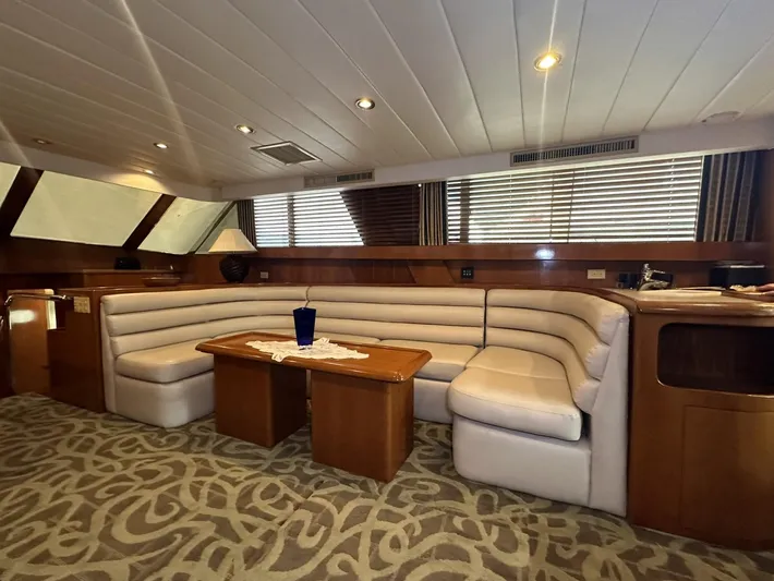 Daddy's Ju-al Yacht Photos Pics Luxurious interior of 1996 President 655 Flybridge Cockpit MY with plush seating and elegant decor.