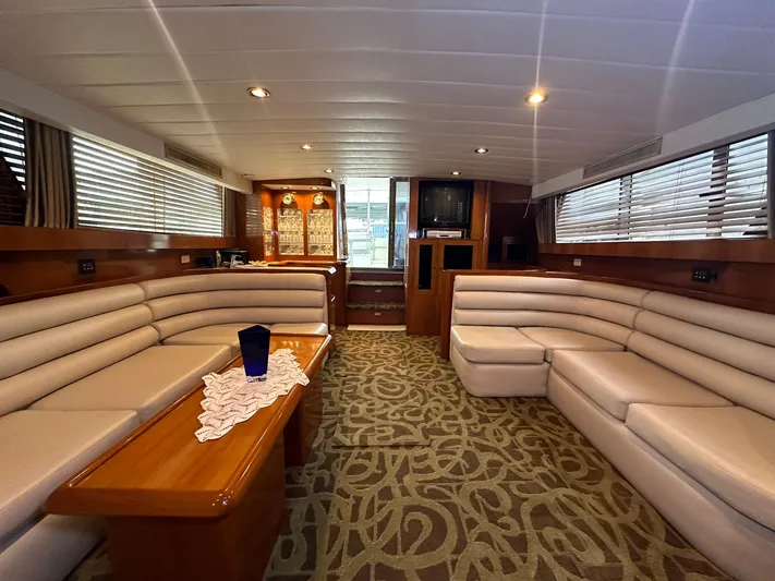 Daddy's Ju-al Yacht Photos Pics Luxurious interior of 1996 President 655 Flybridge Cockpit MY yacht with plush seating.