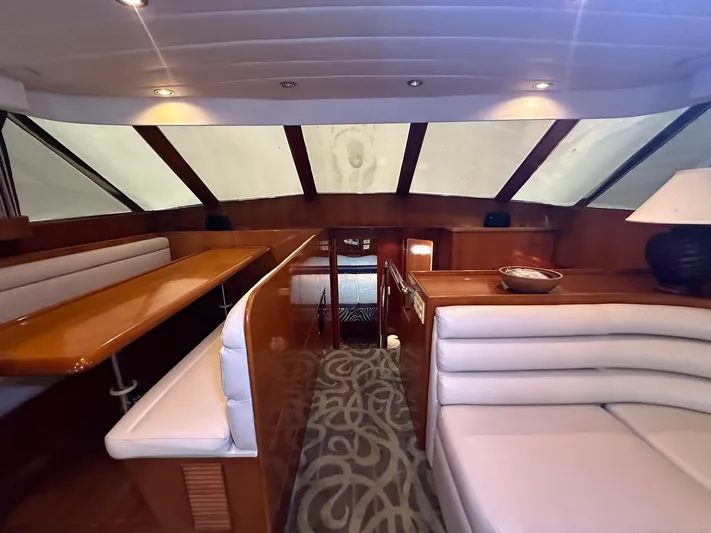 Daddy's Ju-al Yacht Photos Pics Interior of 1996 President 655 Flybridge Cockpit MY yacht with elegant seating and dining area.