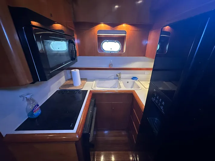 Daddy's Ju-al Yacht Photos Pics Compact kitchen area in a 1996 President 655 Flybridge Cockpit MY yacht.