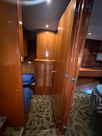 Daddy's Ju-al Yacht Photos Pics Interior of 1996 President 655 Flybridge Cockpit MY with wooden cabinetry and carpeted floor.