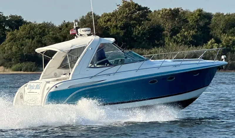  Yacht Photos Pics 2005 Formula 31PC boat cruising on water with trees in the background.