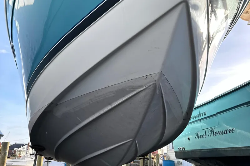  Yacht Photos Pics 2005 Formula 31PC boat hull, docked, showcasing sleek design and vibrant blue color.