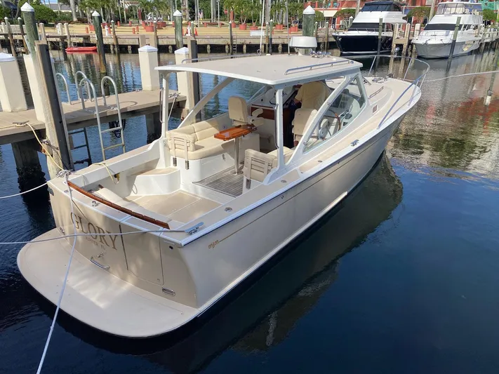 Glory Yacht Photos Pics 2006 MJM 34z Express HT boat docked in a marina, showcasing sleek design and spacious deck.