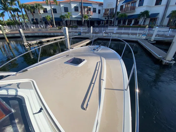 Glory Yacht Photos Pics 2006 MJM 34z Express HT yacht docked at marina with waterfront buildings.