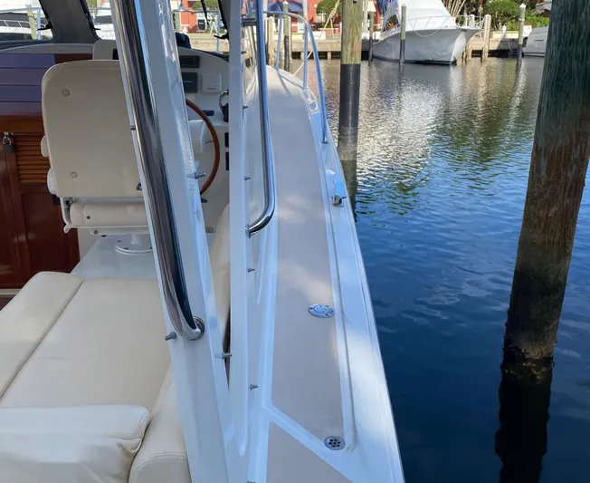 Glory Yacht Photos Pics 2006 MJM 34z Express HT boat docked, showcasing sleek deck and comfortable seating.