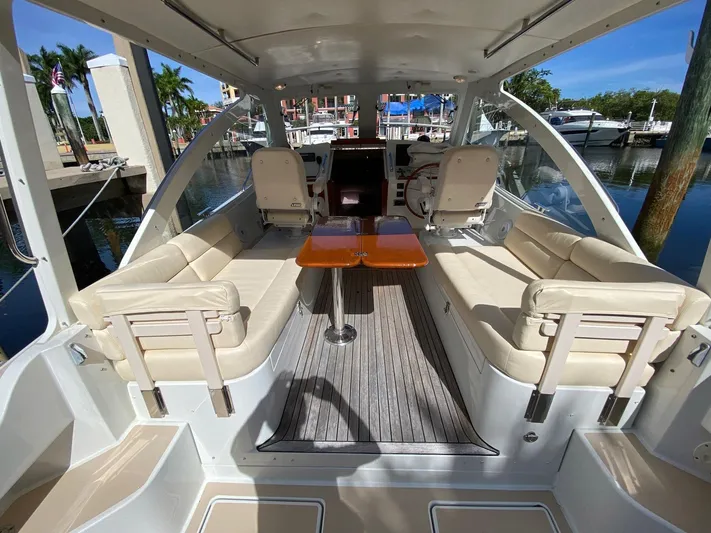 Glory Yacht Photos Pics 2006 MJM 34z Express HT boat interior with seating and table, docked at marina.