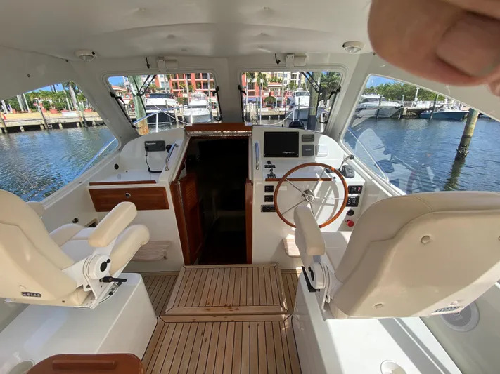 Glory Yacht Photos Pics Interior view of 2006 MJM 34z Express HT yacht with helm and seating.