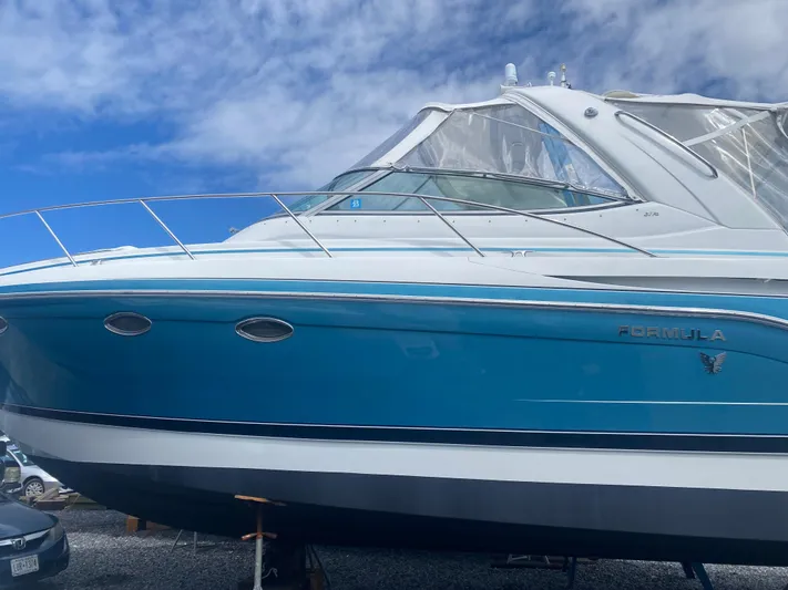  Yacht Photos Pics 2012 Formula 31PC boat with blue hull, docked under a clear sky.