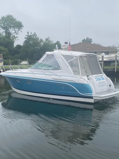  Yacht Photos Pics 2012 Formula 31PC boat docked on calm water, featuring a sleek blue and white design.