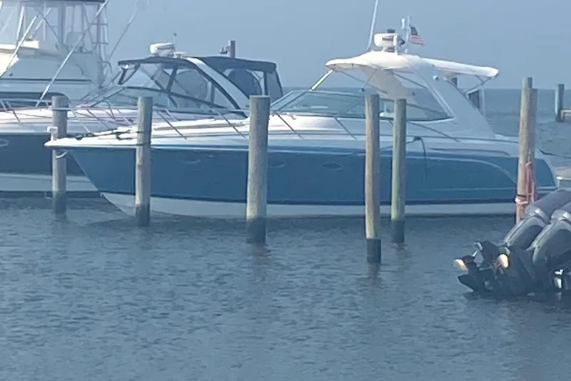  Yacht Photos Pics 2012 Formula 31PC boat docked in marina, blue and white exterior, calm water.