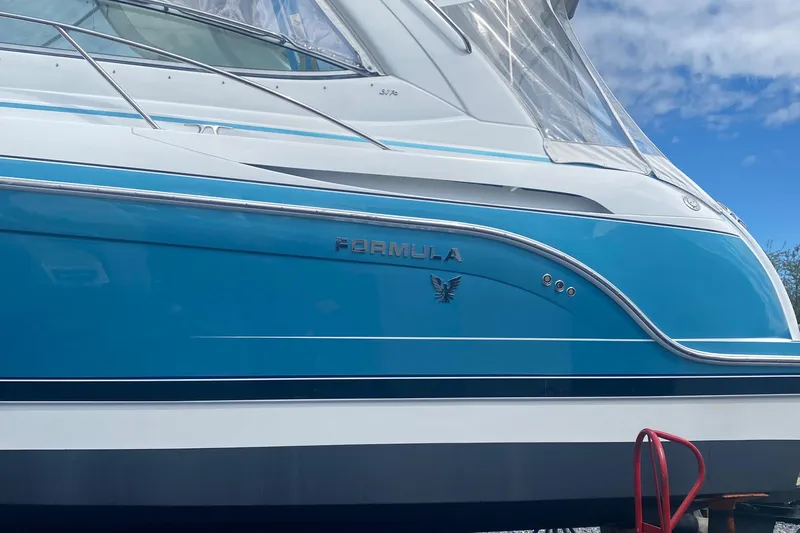  Yacht Photos Pics 2012 Formula 31PC boat with blue and white exterior, docked under a clear sky.