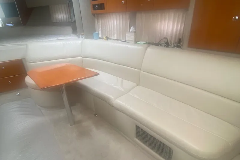  Yacht Photos Pics Interior of 2012 Formula 31PC yacht with white leather seating and wooden table.