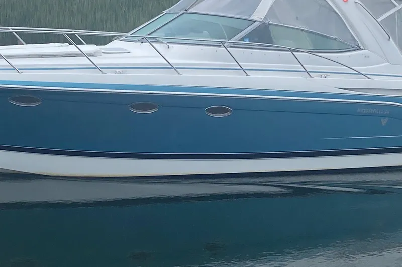  Yacht Photos Pics 2012 Formula 31PC boat with blue hull and sleek design on calm water.