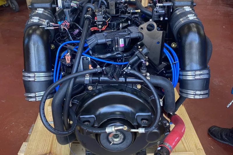  Yacht Photos Pics 2012 Formula 31PC engine with black hoses and blue wiring on a wooden platform.