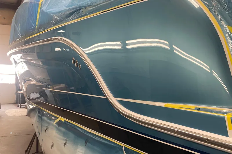  Yacht Photos Pics 2012 Formula 31PC boat with sleek blue hull in a workshop setting.