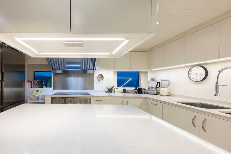 N1 Yacht Photos Pics Luxurious kitchen interior on 2022 Mangusta 165 REV yacht, featuring modern appliances and sleek design.
