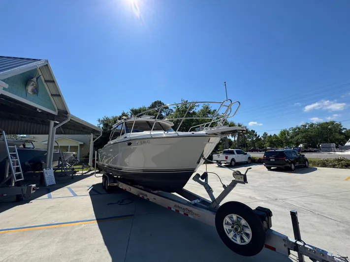  Yacht Photos Pics 2024 Cutwater C-288 Coupe boat on trailer under clear blue sky.