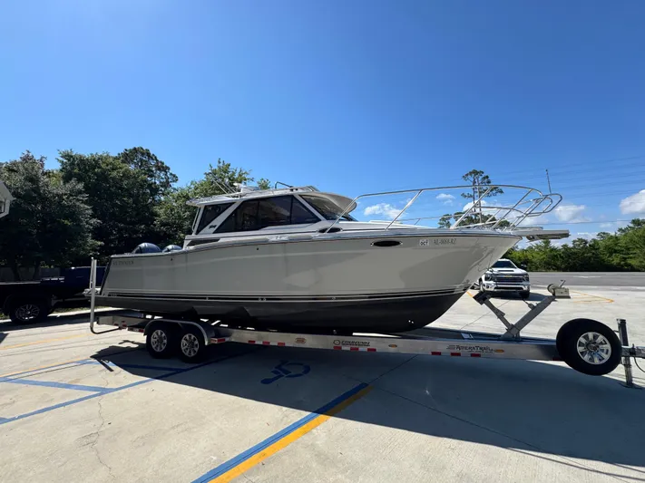  Yacht Photos Pics 2024 Cutwater C-288 Coupe boat on trailer in sunny parking lot.