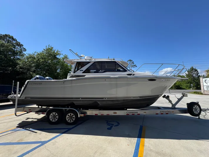  Yacht Photos Pics 2024 Cutwater C-288 Coupe boat on trailer under clear blue sky.