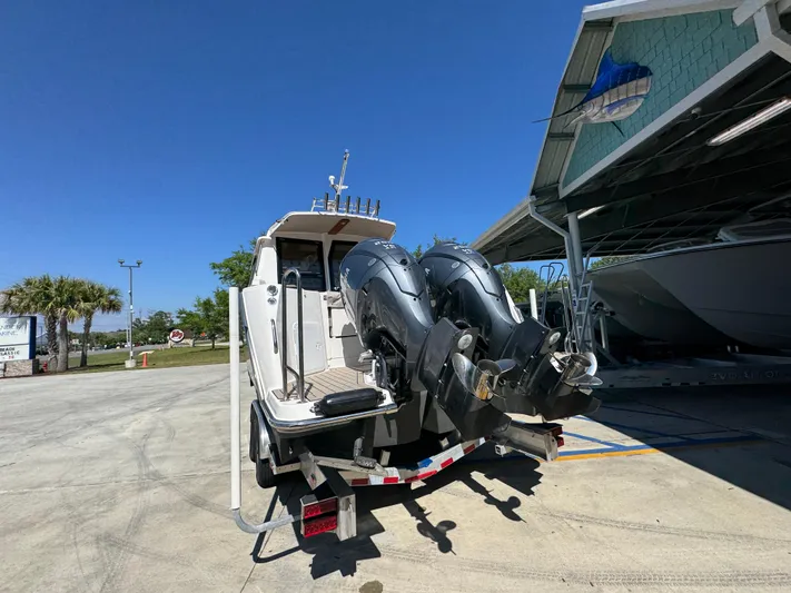  Yacht Photos Pics 2024 Cutwater C-288 Coupe boat with dual outboard motors on a trailer.