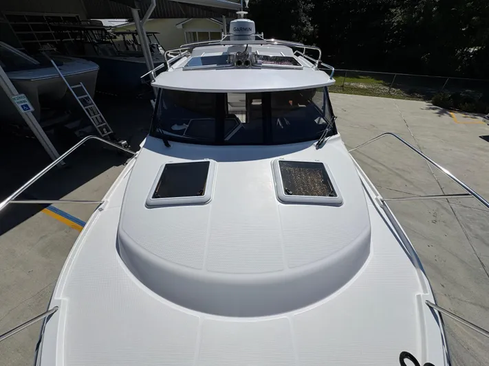  Yacht Photos Pics 2024 Cutwater C-288 Coupe boat, top view, docked outdoors.