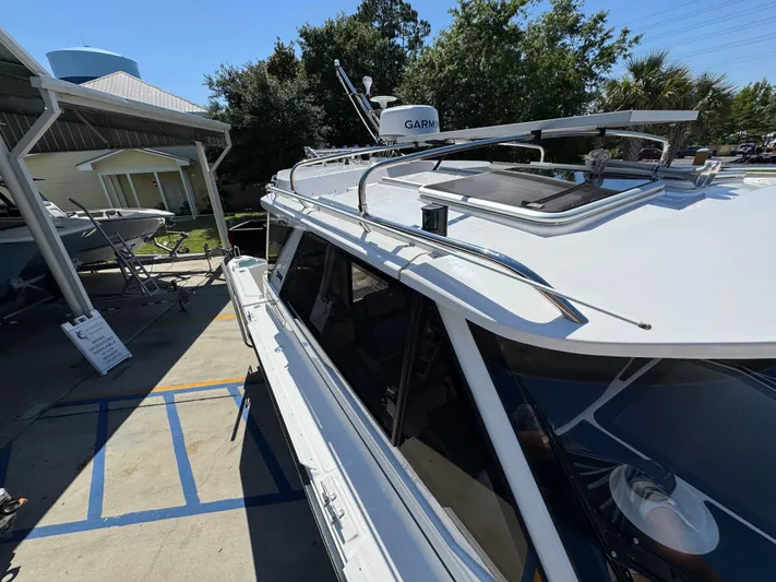  Yacht Photos Pics 2024 Cutwater C-288 Coupe boat docked, showcasing sleek design and advanced navigation equipment.