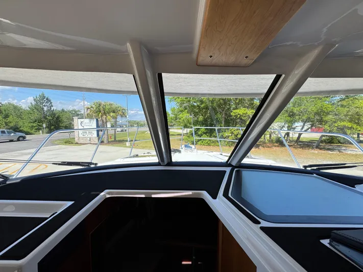  Yacht Photos Pics 2024 Cutwater C-288 Coupe interior view with large windows and modern dashboard.