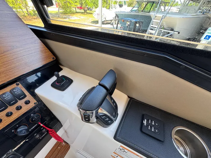  Yacht Photos Pics 2024 Cutwater C-288 Coupe helm controls with joystick and throttle, featuring modern design elements.