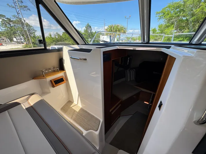  Yacht Photos Pics 2024 Cutwater C-288 Coupe interior with seating and cabin entrance.