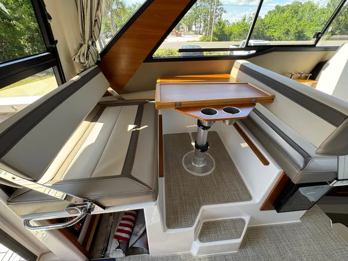  Yacht Photos Pics 2024 Cutwater C-288 Coupe interior with seating and table, featuring modern design and natural light.