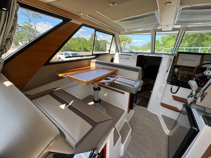  Yacht Photos Pics 2024 Cutwater C-288 Coupe interior with seating, table, and navigation equipment.