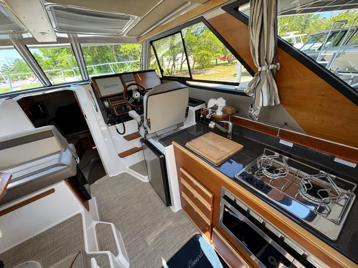  Yacht Photos Pics 2024 Cutwater C-288 Coupe interior with modern kitchen and navigation area.