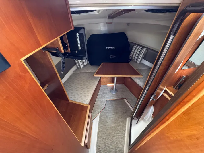  Yacht Photos Pics 2024 Cutwater C-288 Coupe interior with wood finish, seating, and table.