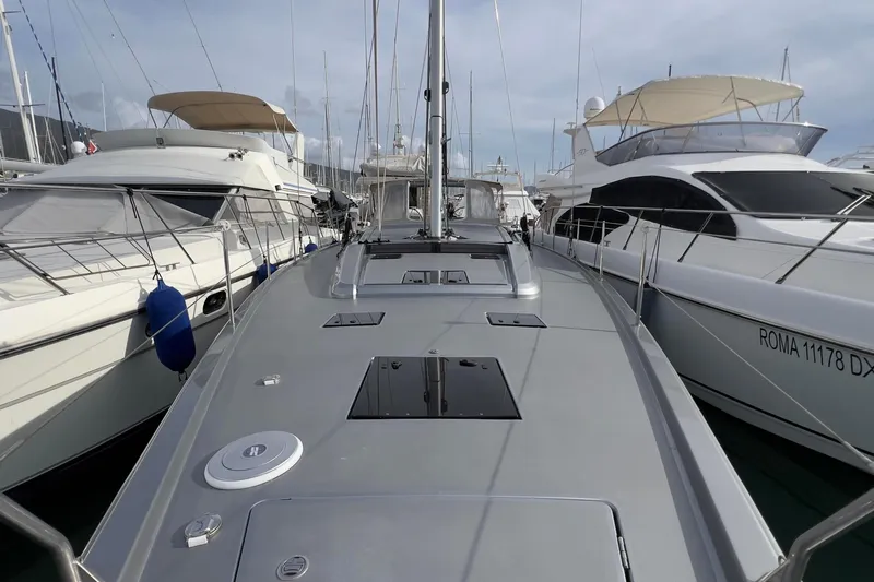  Yacht Photos Pics 2017 Grand Soleil 52 LC yacht docked between two boats in a marina.