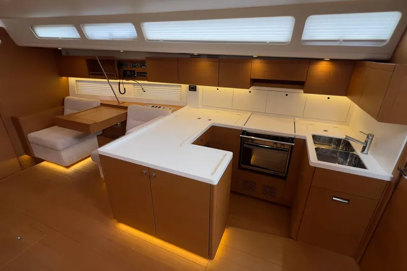  Yacht Photos Pics Modern kitchen interior of 2017 Grand Soleil 52 LC yacht with sleek cabinetry and appliances.