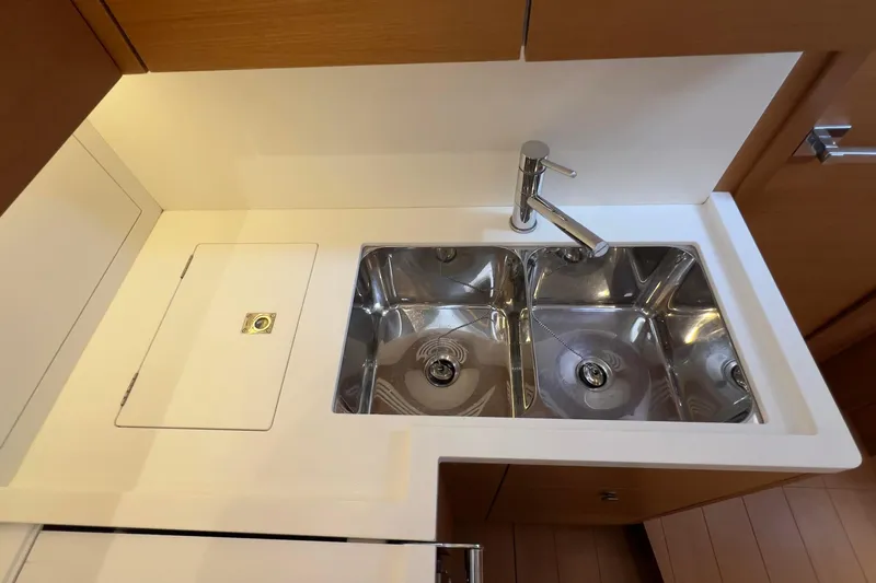  Yacht Photos Pics Modern kitchen sink in 2017 Grand Soleil 52 LC yacht, featuring dual basins and sleek faucet.