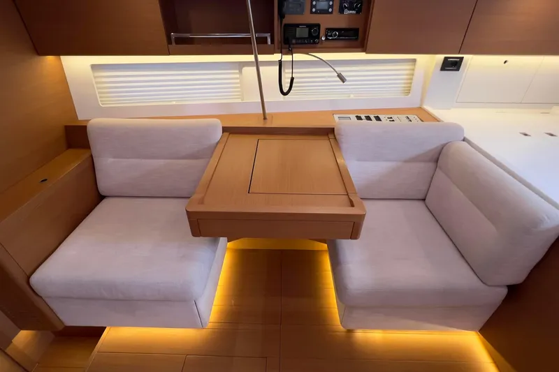  Yacht Photos Pics Luxurious 2017 Grand Soleil 52 LC yacht interior with cozy seating and elegant wood finish.
