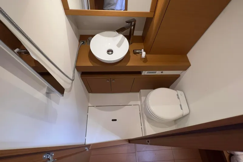 Yacht Photos Pics Bathroom interior of 2017 Grand Soleil 52 LC yacht, featuring modern sink and toilet.